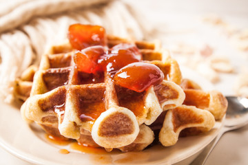 Home made heart shaped waffles served in a traditional cast iron waffle pan.