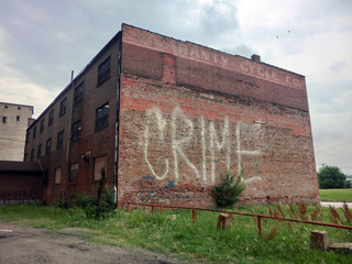 Crime" painted on brick building in St. Louis, Missouri - landscape color photo