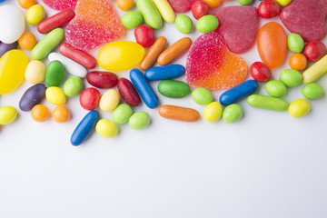 Border of colorful jelly candies on white