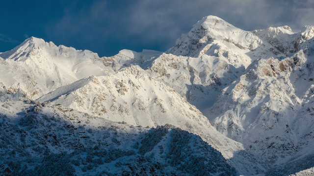4K Timelapse. Clouds over the snow-capped peaks of the mountains
