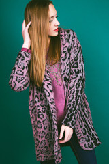 Studio photo of young  woman on green background