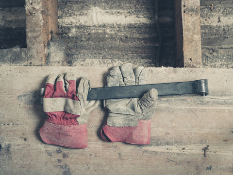 Gloves and crowbar on floor