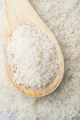 food background. brown rice in a wooden spoon. top view