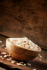Puffed rice in a wooden bowl, selective focus