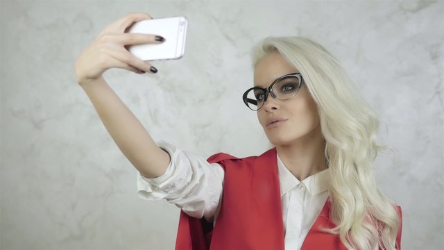 Beautiful Young Woman With Glasses Making Selfie