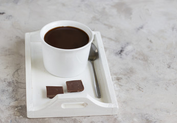 Cup of hot chocolate on wooden tray
