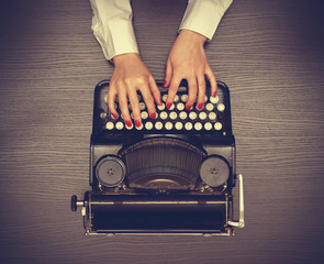 Hands typing on a Vintage typewriter