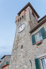Fototapeta na wymiar The clock tower in the historic center of Passignano - Umbria