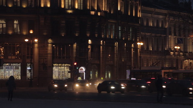 Night city of Saint Petersburg with lights of buildings and traffic. Illuminated buildings and streets.