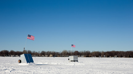 Ice Shanties on Frozen Lake with American Flags