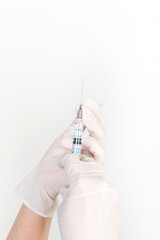 Hand in glove with syringe on a white background, disease treatment, treatment room, medical staff