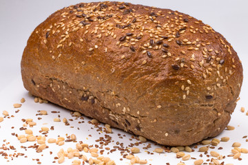 baked bread with seeds on white background
