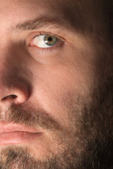 Fototapeta premium Intimate closeup of a white sexy hot attractive man with mustache beard and hazel eyes looking intense serious thoughtful authentic real beautiful accusatory
