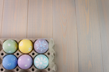 Easter colored eggs in a box. Empty space for text.