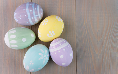 Easter painted eggs on wooden light background. Empty space for text.