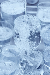 Glassware under a water jet in the kitchen sink