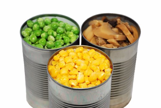 Selective focus of canned vegetables on a white background