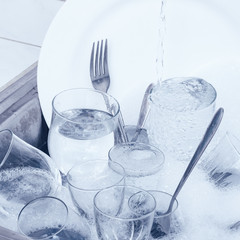 Glassware,cutlery and dishes in the kitchen sink