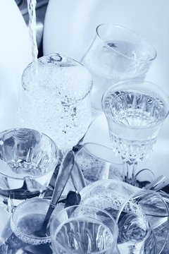 Glassware,cutlery and dishes in the kitchen sink
