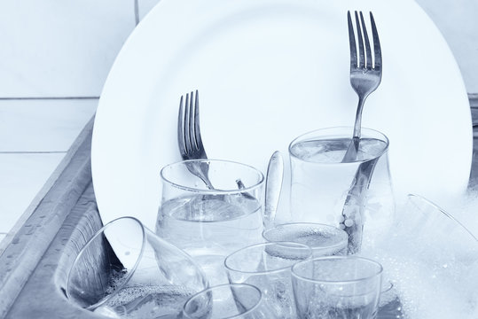 Glassware,cutlery and dishes in the kitchen sink