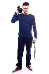 isolated portrait of handsome young man photographer posing and holding a camera