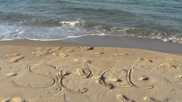Wordds "Sea" on beach
