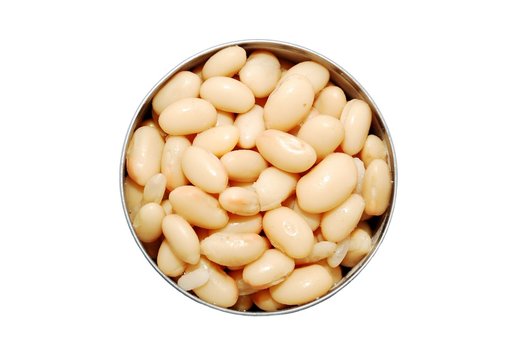 Top view of an open can of cannellini beans on a white background