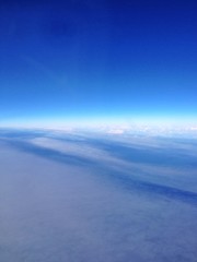 blue sky and clouds from airplane window