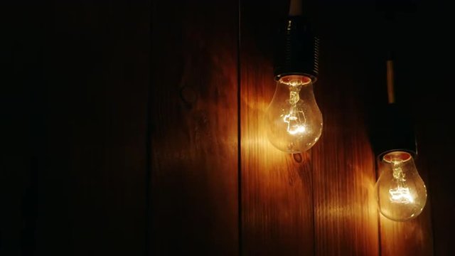 Light up the two light bulbs on a wooden background
