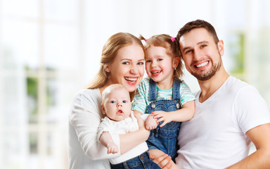 Obraz premium happy family mother, father and children at home