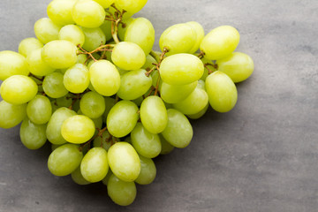 Grape cluster on the grey background.