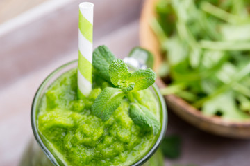 Rucola smoothie, on the grey  background.