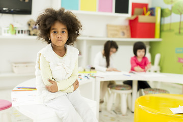 Multiracial children drawing in the playroom