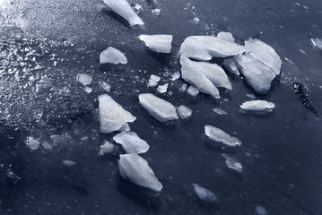 Pieces of ice on the frozen water