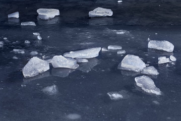 Pieces of ice on the frozen water