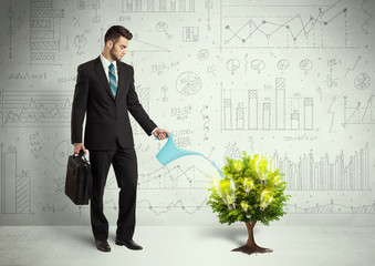 Business man pouring water on lightbulb growing tree