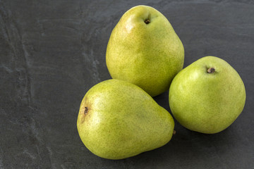 Green Anjou Pears on the slate background