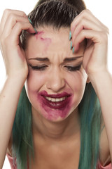 desperate and crying young woman with smeared makeup