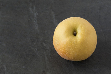 Single Asian Pear on the slate background

