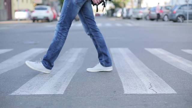 Man crossing the road at a zebra.