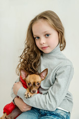 blond kid girl with small pet dog