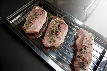 Meat and pepper on a metal lattice for a grill
