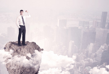 Winner business person standing on rock