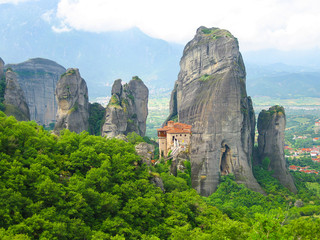 Meteora, Greece. Mountain scenery with Meteora rocks and Roussanou Monastery, landscape place of monasteries on the rock, orthodox religious greek landmark in Thessaly