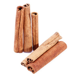 group of dried cinnamon stics isolated on white background