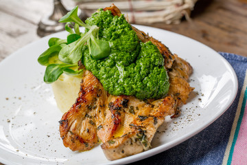 Tasty grilled chicken breast with pesto sauce and mashed potatoe
