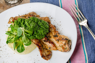 Tasty grilled chicken breast with pesto sauce and mashed potatoe