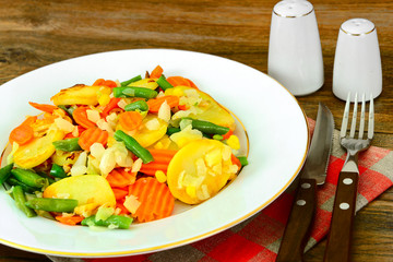 Steamed vegetables potatoes, carrots, corn, green beans and onio