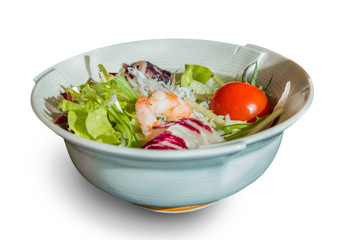 salad of shrimp, mixed greens in ceramic bowl.