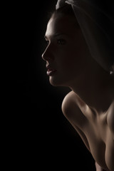 Silhouette profile of a beautiful young woman with a towel on her head